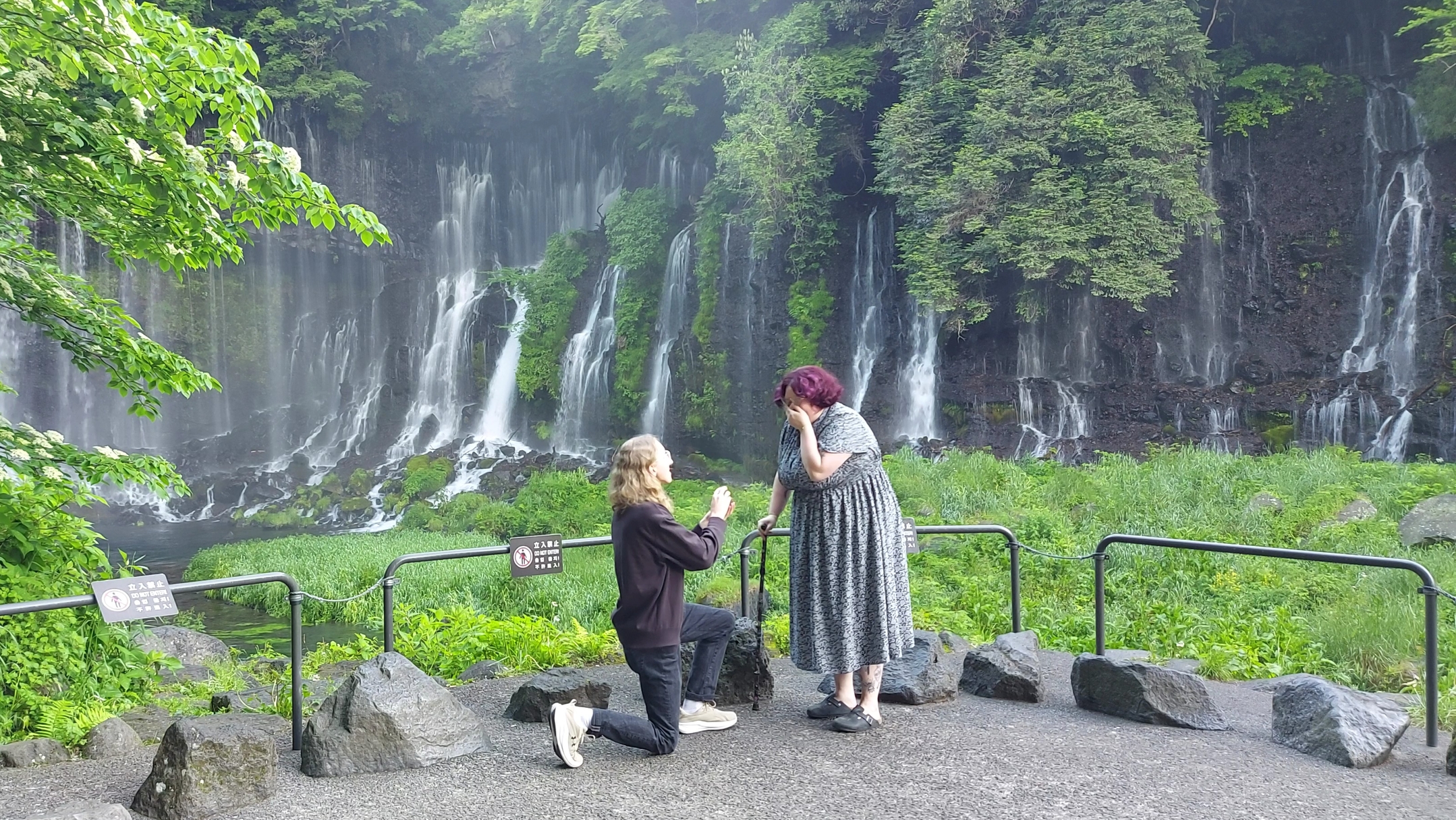 Rae and Stanley's proposal in front of waterfalls